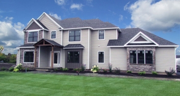 Crown-Point-Merle-Parade-front-elevation-photo-with-blue-sky-green-grass