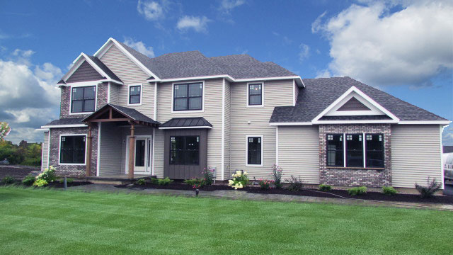 Crown-Point-Merle-Parade-front-elevation-photo-with-blue-sky-green-grass