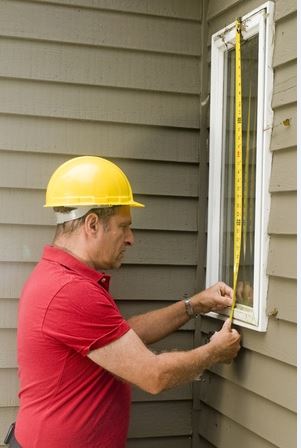 Home renovator measuring windows for project